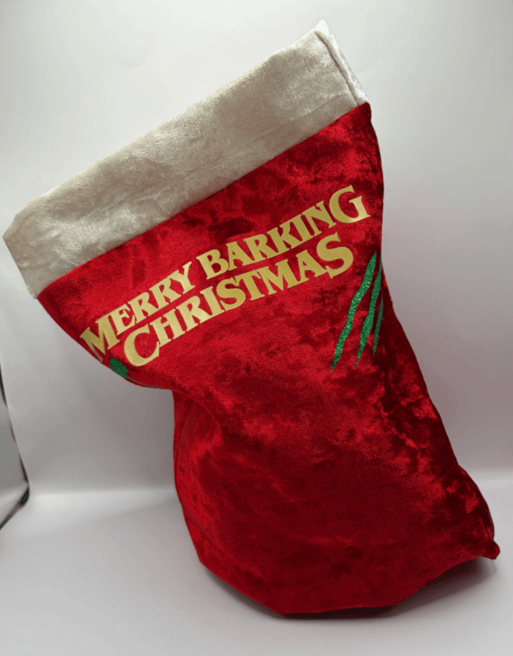 Side view of a red velvet Fur Baby Santa Sack with Merry Barking Christmas design