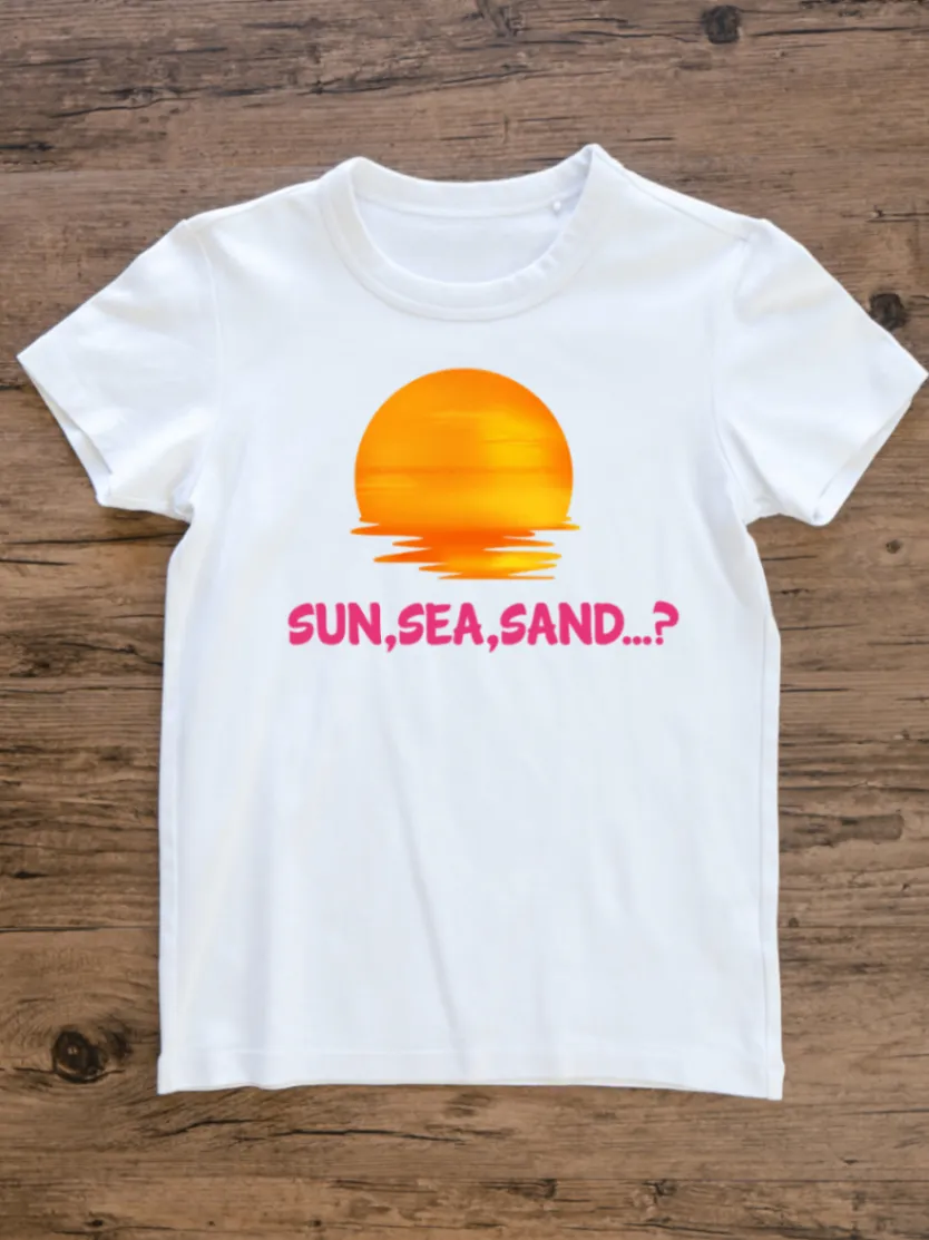 White T-shirt laid on rustic wood with an orange sunset graphic and pink SUN, SEA, SAND...? lettering