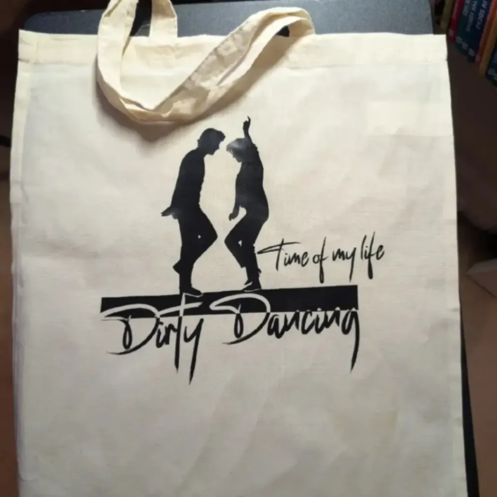 Cream tote bag with a black dancing couple silhouette and custom Dirty Dancing lettering